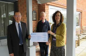 Sally Daniels receives a cheque for £5000 from  Peter Moore & Andrew Rycraft